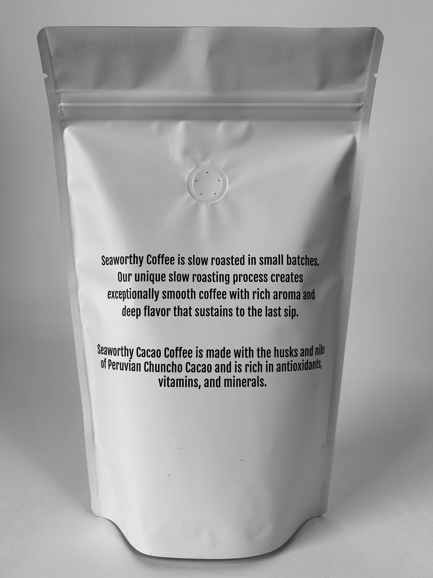 The back of the white Seaworthy Coffee bag of Cacao Coffee. Seaworthy Cacao coffee is a premium blend of Peruvian Chuncho Cacao husks and nibs blended with ground Brazilian slow roasted coffee.